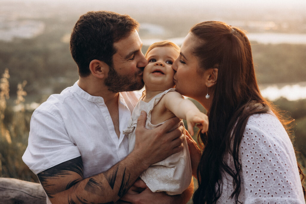 Séance photo famille au Pech-David à Toulouse au coucher du soleil, bébé fête son premier anniversaire, moments authentiques et lumineux en extérieur.